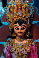 Fototapeta premium God Kartik idol, decotaed during Durga Puja festival at night. Shot under colored light at Howrah, West Bengal, India. Biggest festival of Hinduism , celebrated all over the world.