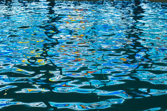 Colorful reflections on the water in the swimming pool