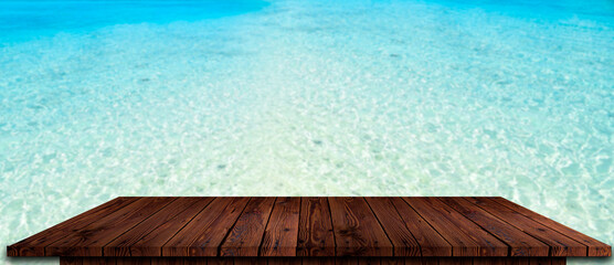 Wood table top on blurred beach background, summer concept - can be used for display or montage your products