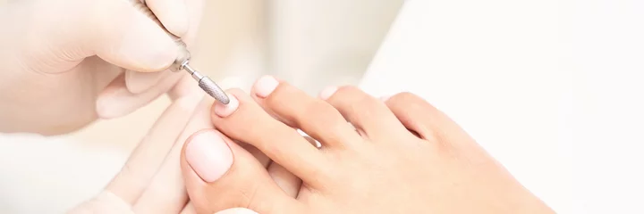 Rideaux occultants Pédicure Beautiful salon procedure with pink pedicure on towel background. For decoration design. Healthcare. Woman body care. Spa treatment. White background. Nail machine polish. Medical