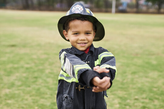 Little boy playing fireman with imaginary hose