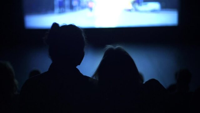 Loving couple watching romantic movie in cinema. Difference between dating and being in a relationship.