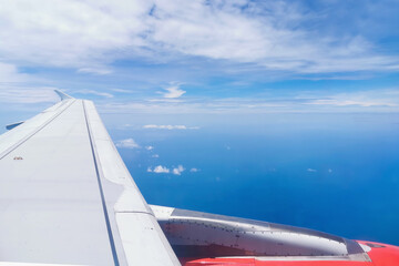 Aircraft Jet Engine turbine wing with fluffy clouds.