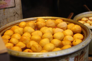 Close up of a big bowl of delicious curry fish balls, soft focus