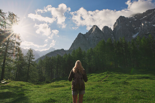 Adventure travel hiker woman in beautiful forest on scenic mount