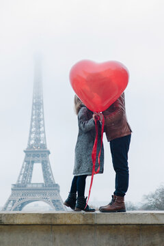Couple kissing on the background of the Eiffel Tower