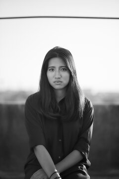 Black and white portrait of a woman staring at the camera.
