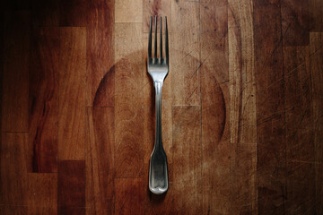 Vintage fork on a wooden background