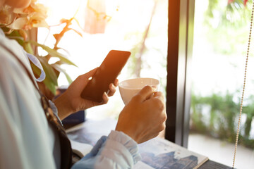 Hand put a Latte arts coffe hot coffee on wooden table.barista love art concept.