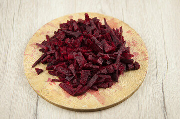 pile of beetroot strips on wooden cutting board - close up