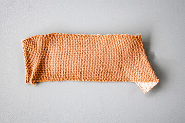 First aid plaster isolated on gray background. A medical equipment bandage.