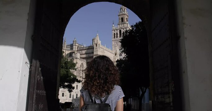 girl walking and sightseeing the streets of seville, spain