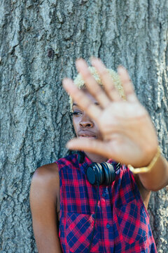 Portrait of a cool woman showing the hand palm to the camera
