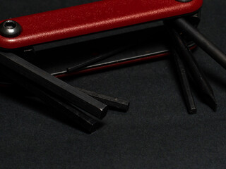 Close-up  of allen key and screwdriver set, isolated on black background