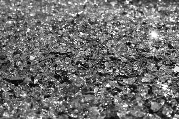 Black and white concept of car theft, broken glass on road