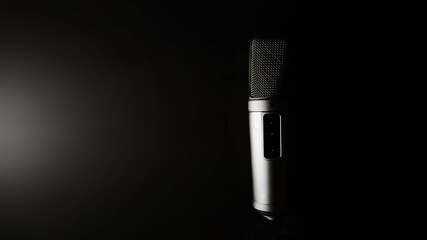 Studio condenser microphone on a black background. Professional sound equipment in the studio. Top view, copy space

