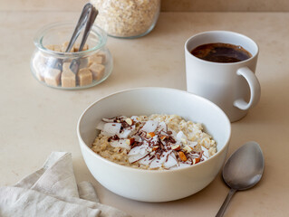 Oatmeal porridge with almonds, coconut and chocolate. Healthy eating. Vegetarian food. Breakfast. Diet.