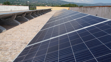 System of solar panels on roof of modern residential building, sustainable green renewable energy