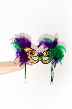 Woman Holds Mardi Gras Mask