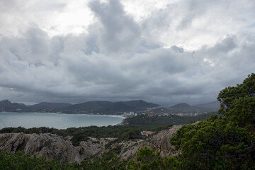 View to the bay of Cala Ratjada, Majorca, Spain. Stormy clouds and sea.