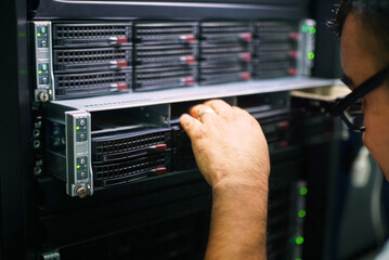 Computer professional working on data center supercomputer server