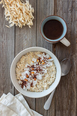 Oatmeal porridge with almonds, coconut and chocolate. Healthy eating. Vegetarian food. Breakfast. Diet.