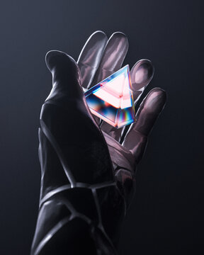 Gloved handed holding pyramid-shaped prism