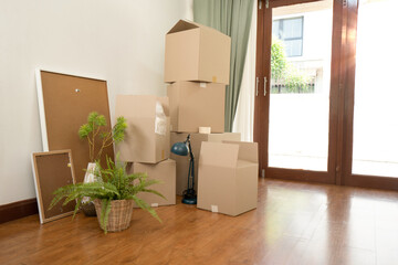 Different cardboard Moving boxes with belongings for moving at room interior movement or delivery concept