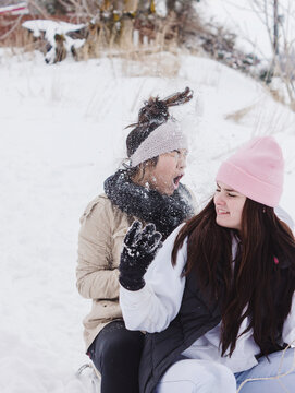 teenager reacting to snow thrown in her face