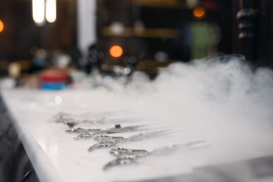 Close up on hairdresser scissors aligned on white table