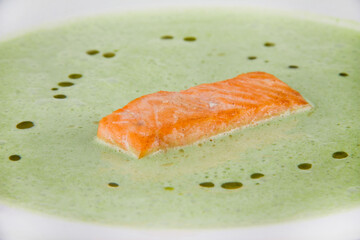 Green spinach puree soup with salmon slices