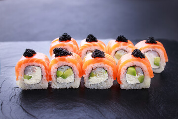 Seafood delicatessen salmon sushi rolls on slate