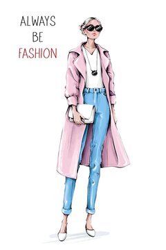Hand drawn beautiful young woman wearing coat and jeans. Stylish girl in sunglasses holding white bag. Fashion woman look. Sketch. Fashion illustration.