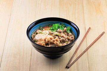 Thai style spicy noodles on wooden board background