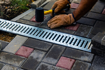 Installation of light metal grating and gutters for drainage of rainwater and paving slabs....