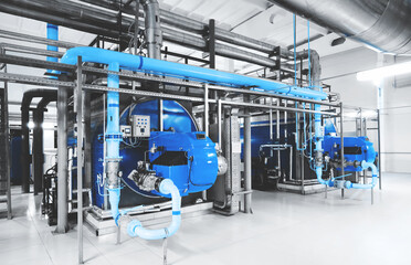 Interior of modern industrial gas boiler room with two gas boilers and pipes for supplying gas and...