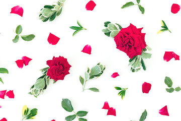 Floral pattern of red roses flowers and green leaves on white background. Flat lay