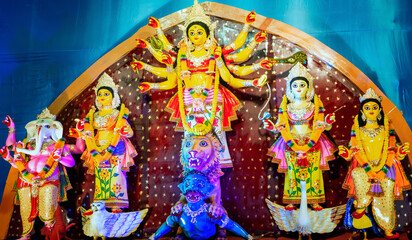 Fototapeta premium Durga Puja or Durgotsava,is an annual Hindu festival celebrated mainly in West Bengal,Indian.Durga is Goddess riding a lion with many arms each carrying weapon and defeating evil power of Mahishasura.
