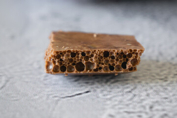 A piece of aerated milk chocolate close up
