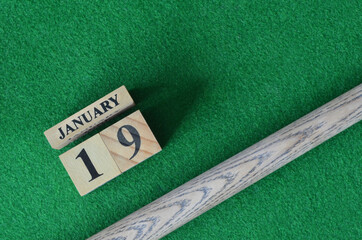 January 19, Number cube With a snooker stick on a green background, snooker table.
