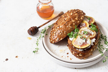 Toast with whole grain bread, cottage cheese and figs. Healthy food concept.