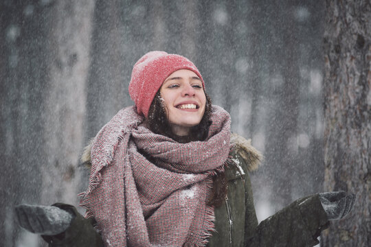 Portrait of a young happy woman in the snow
