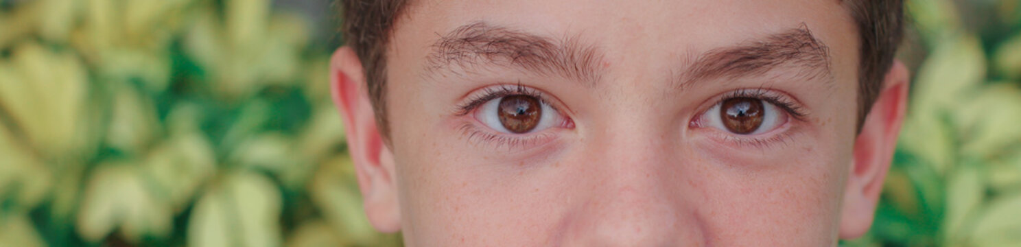 close up of a teen boys brown eyes 