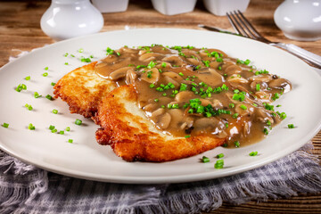 Crispy potato pancakes with mushroom sauce