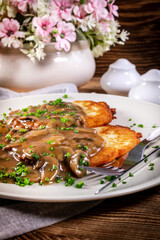 Crispy potato pancakes with mushroom sauce