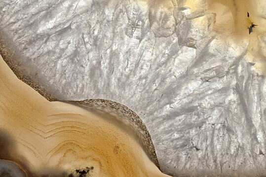 Closeup of patterns and textures in a slice of agate showing crystalline patterns