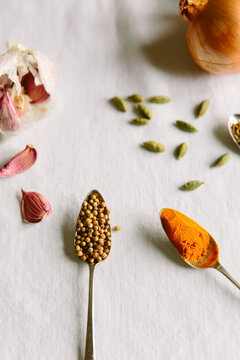 Coriander seeds, turmeric and other spices and vegetables.