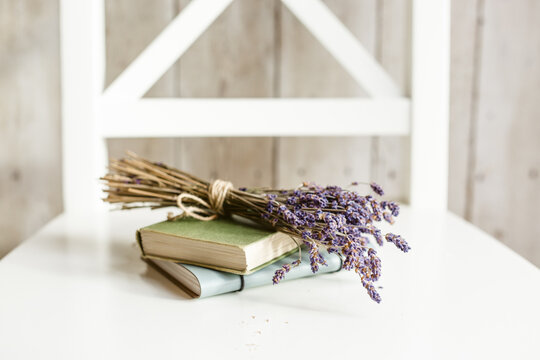 Lavender flowers and books on a chair