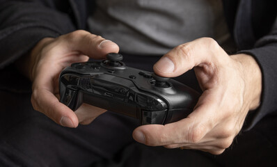 Man holding black game controller - Selective Focus © miglagoa