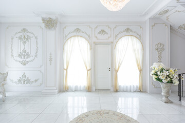 luxury royal posh interior in baroque style. very bright, light and white hall with expensive...